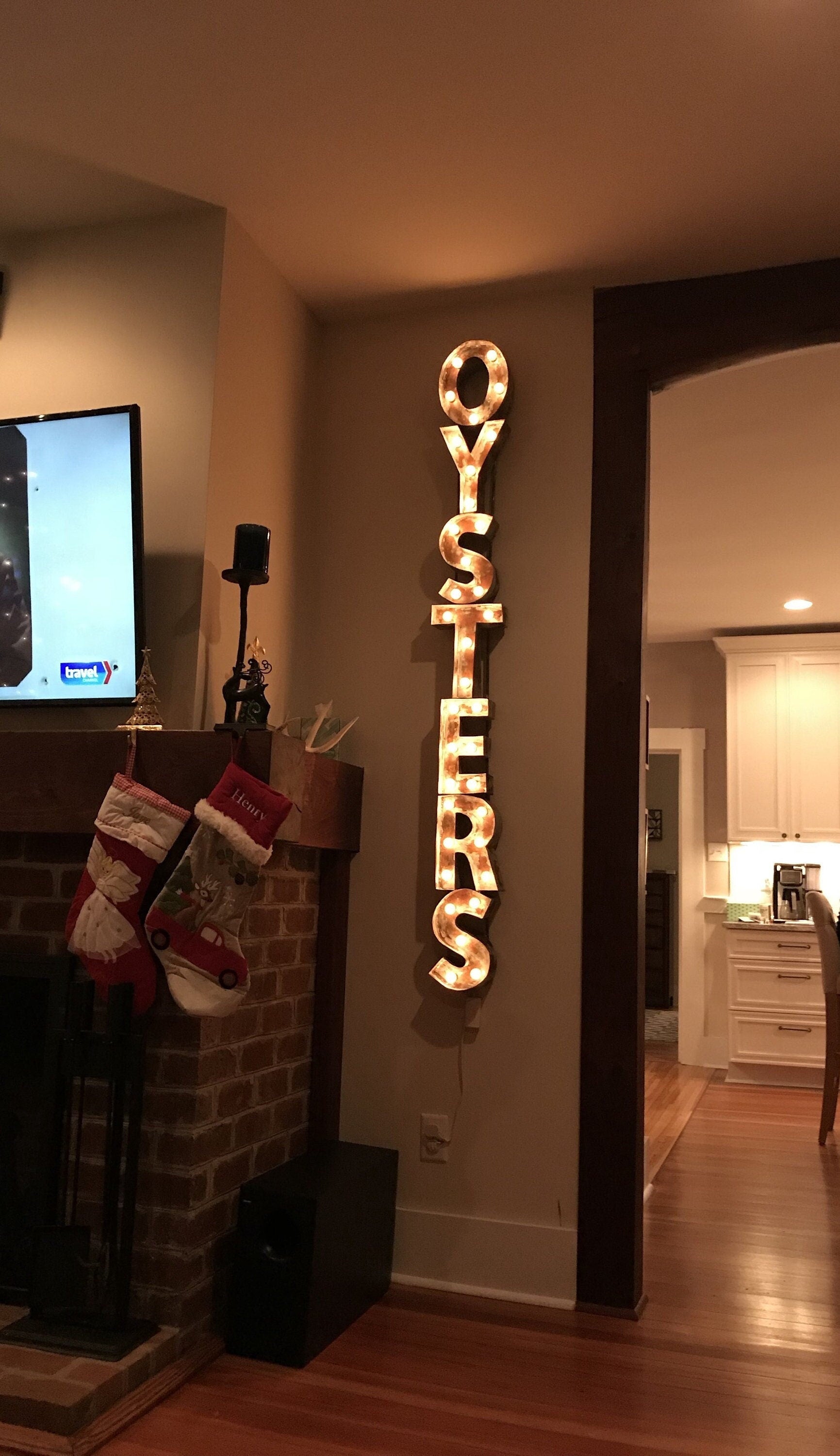 Image of letters spelling the word "Oysters" in a lit sign.